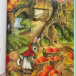 Martha b rabbit is outside collecting baskets of apples. The leaves are fall colours. You can see a beehive and a wood store in the background 